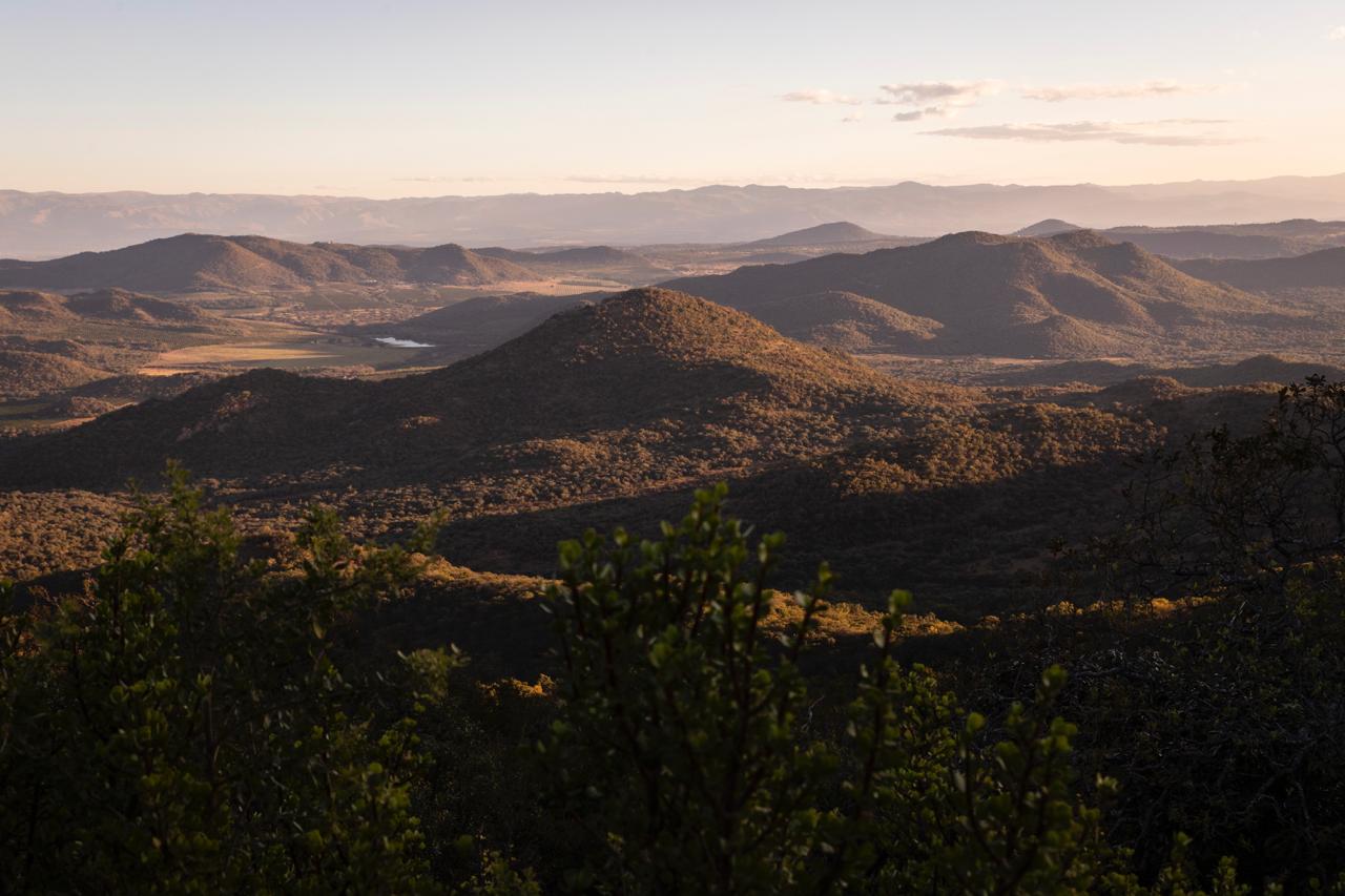 Golden-hour light over the Lowveld valley and dam at Gold Valley Mountain Venue